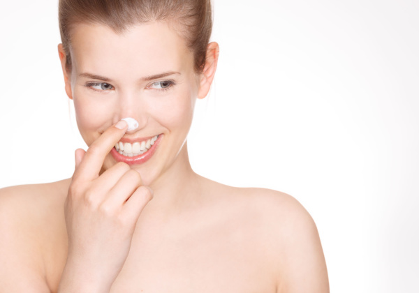 photo of cream care product like nivea on a models nose.